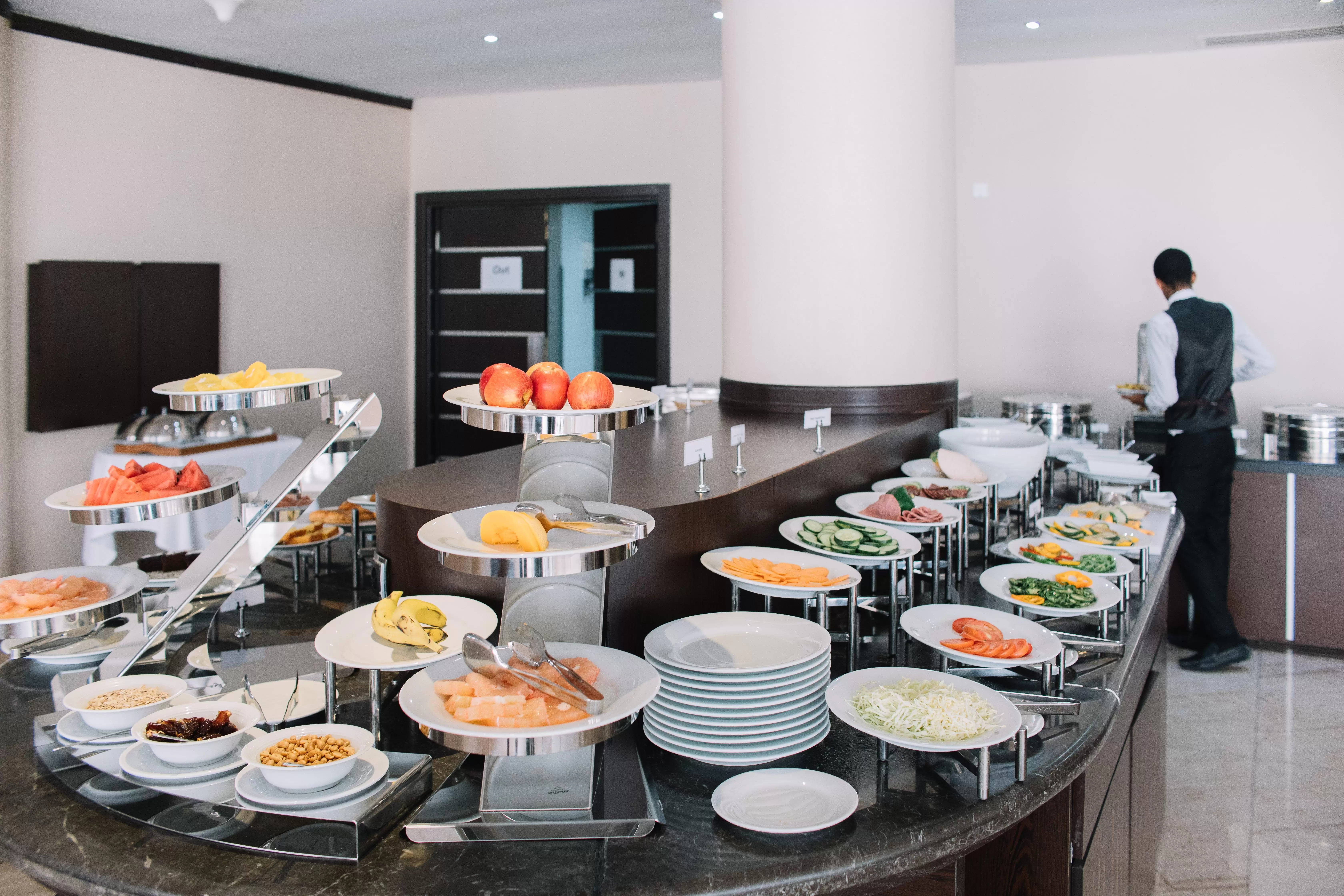 a picture of the breakfast buffet at best western plus hotel in addis ababa with fruit, cereal, salads, egg dishes, and ore.