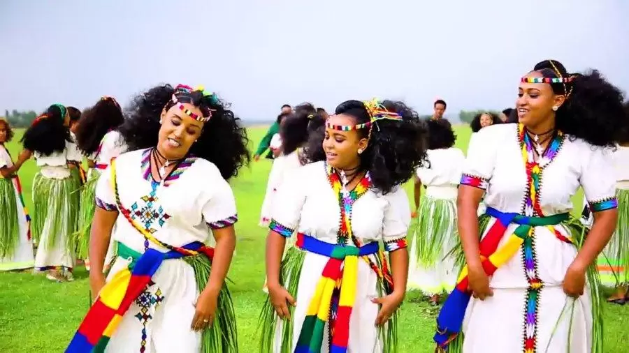 a picture of 3 women wearing festive clothes and dancing for ashenda